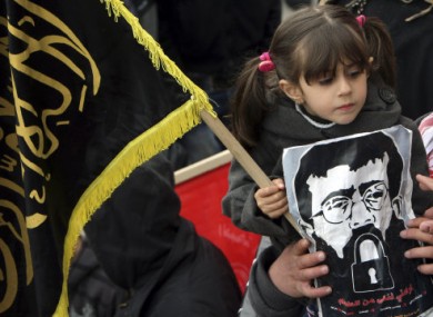 Maali Adnan, 4, holds a picture of her father during a recent solidarity protest in Arrabeh, the West Bank.