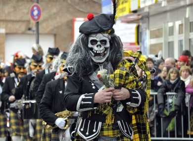 An eerie piper participating in a carnival parade in Cologne, Germany today.