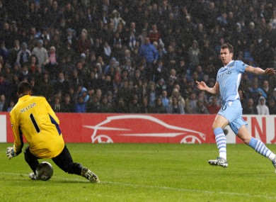Edin Dzeko (right) shoots to score Manchester City's second goal past FC Porto's goalkeeper Da Silva Helton.