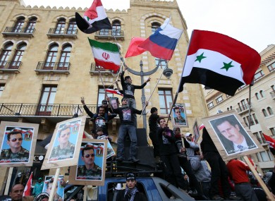 Pro-Syrian regime supporters during a demonstration in Lebanon yesterday