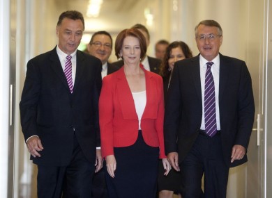 Australian Prime Minister Julia Gillard, centre, accompanied by supporters Craig Emerson (L) and Wayne Swan leave a caucus meeting after she won the vote for party leadership at Parliament House in Canberra.
