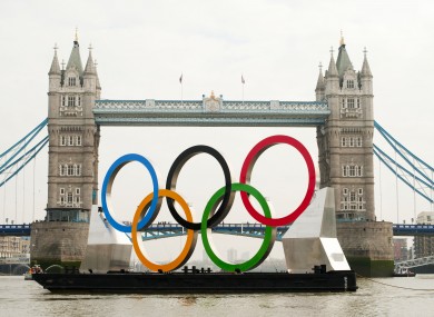 Giant Olympic rings are floated down the river Thames, to mark 150 days to go until the start of the 2012 Olympics