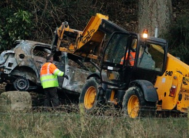 The burnt-out car is removed from the scene yesterday.