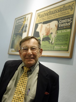 Peter Sachs poses for media in front of two posters, pieces from his father Hans Sachs' Poster Collection, at the German Historical Museum in Berlin