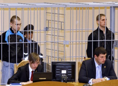 Dmitry Konovalov, left, and Vladislav Kovalyov stand in a defendant's cage during their trial in September 2011.