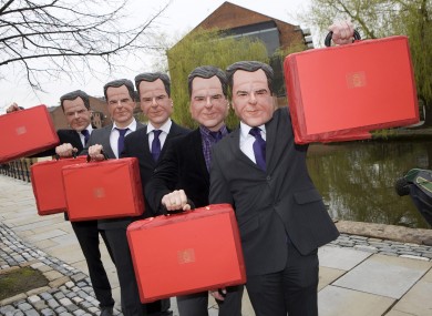Five people dressed as Chancellor George Osborne mark the UK Budget Day in Manchester.