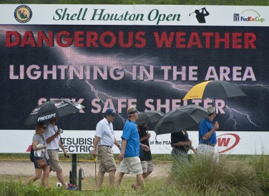 Patrons head for cover during a lightning delay in yesterday's Shell Houston Open first round.