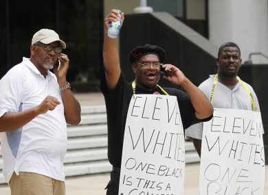 Demonstrators react as they found out the five police officers were convicted of the shooting last year