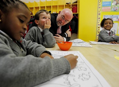 Education Minister Ruairí Quinn with school children in Dublin yesterday.