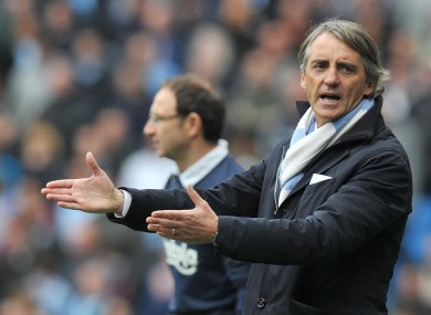 Roberto Mancini: title race is over if city lose at Arsenal, he says.