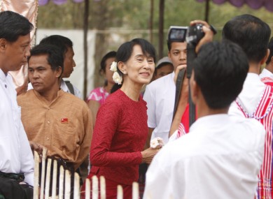 Suu Kyi, center, heads towards a polling station at Wah Thin Kha village in Yangon earlier today.