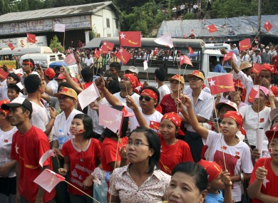 Supporters of the National League for Democracy gather outside the party headquarters in Yangon to await news from the national by-elections.