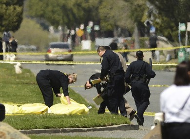 Oakland Police cover bodies after the shooting