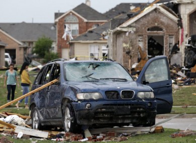 A damaged vehicle and homes in FOrney, Texas after yesterday's storms.