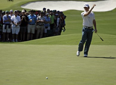 McIlroy acts to a missed putt on the third green.