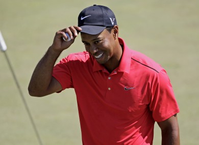 Woods acknowleges the crowd after putting on the 18th green on Sunday.