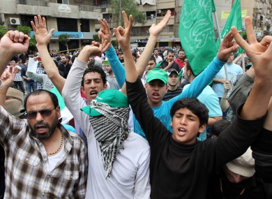 Supporters of an Islamic group and Lebanon's Future Movement of former Prime Minister Saad Hariri, shout slogans as they march during a demonstration against the Syrian regime