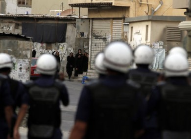 Anti-government protesters shout at riot police yesterday in Sanabis, Bahrain, on the edge of the capital Manama.