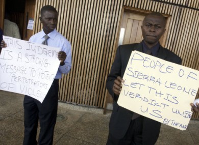 Some of the signs carried outside the Special Court yesterday.