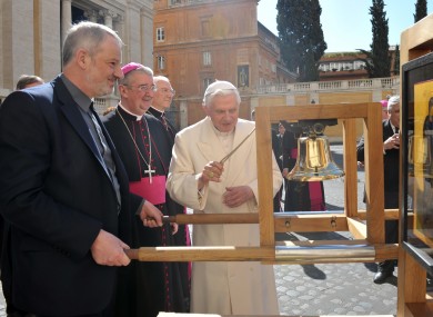 Pope Benedict XVI rings the bell of the International Eucharistic Congress, watched by Fr Kevin Doran and Dr Diarmuid Martin.