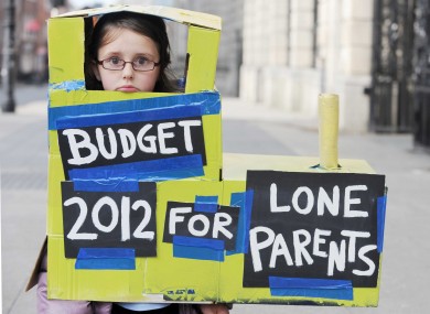 Rebecca Caffrey, aged 8, rides the 'gravy train' outside Leinster House. She was participating in a protest at government plans to withdraw the One-Parent Family Payment to parents of children aged 7 and over.