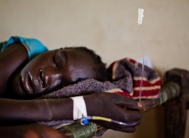A teenage girl sleeps in a hig fever,suffering from Malaria in South Sudan, Africa