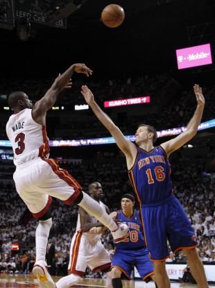 Miami Heat's Dwyane Wade (3) shoots past New York Knicks' Steve Novak (16) in the first half.