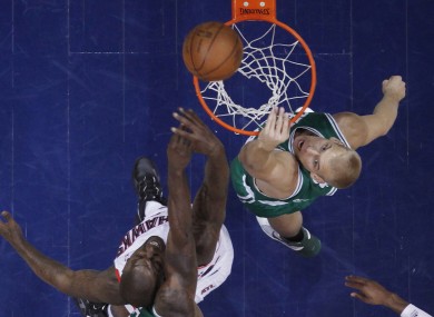 Atlanta Hawks forward Ivan Johnson, left, and Boston Celtics center Greg Stiemsma go up for a rebound.
