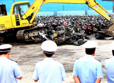 More than 4,000 confiscated illegal motorbikes are destroyed by diggers in the city of Foshan, Guangdong, China.