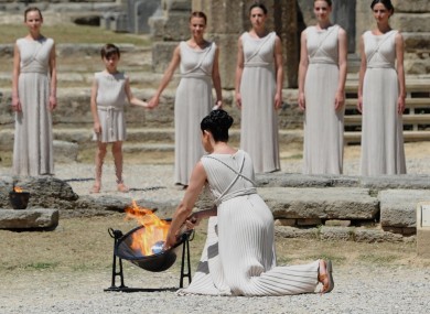 The Olympic Flame is lit by an actress dressed as the High Priestess this morning.