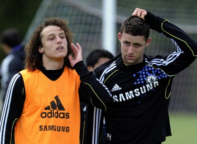 David Luiz, left, and Gary Cahill leave the pitch after a training session at the Cobham training ground yesterday.