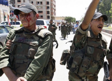 A bloodied soldier following the incident in Deraa today.