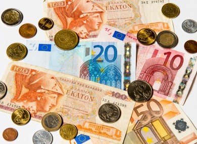 A collection of old Greek Drachma and euro notes and coins
