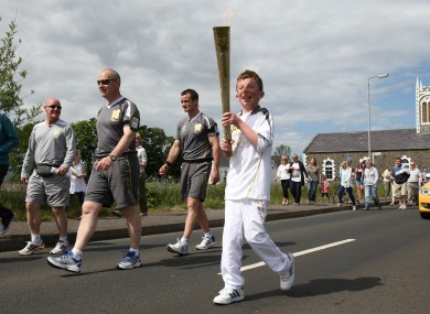 Torchbearer 020 Kiernan McLaughlin carries the Olympic Flame on the Torch Relay leg between Bellarena and Greysteel.