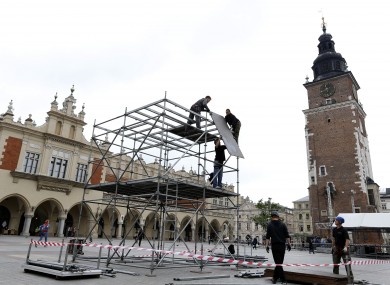 Workers build a stage area in the main square, ahead of the Euro 2012 kick-off, in Krakow today.
