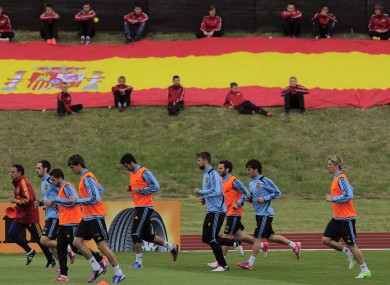 Spain's team warm up during their training session in front of Spanish flag earlier.