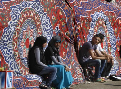 Young people sitting at a traditional coloured tent at Tahrir Square, Cairo.