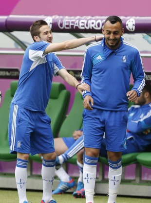 Costas Fortounis, left, and Costas Mitroglou joke during yesterday's training session.