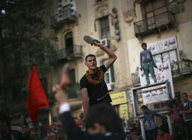 A protester chants slogans against the regime in Tahrir Square, Cairo today.