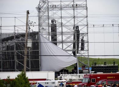 Emergency workers around the collapsed stage after the accident