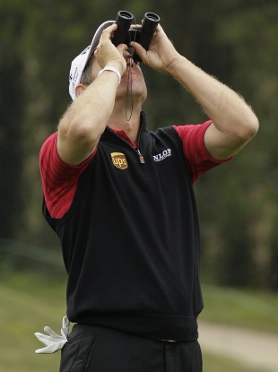 Lee Westwood looks for his ball in a tree on the fifth hole during the fourth round of the US Open.
