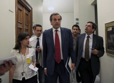 Antonis Samaras, centre, speaks to journalists on Monday.