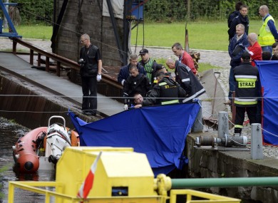 Police divers retrieve the body of James Nolan from a canal in Bydgoszcz yesterday. The body was officially identified by his family last night.