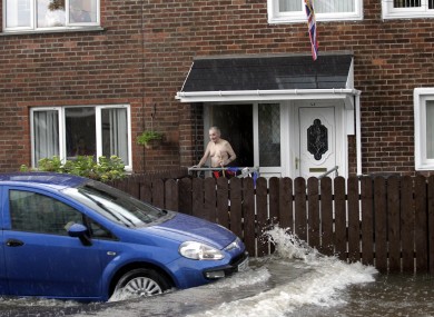 A motorists in the Cregagh area of East Belfast struggles to get through the flash floods.