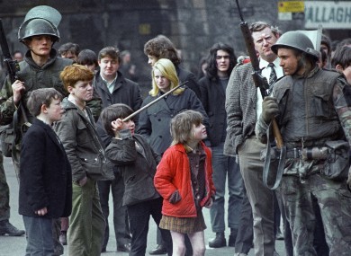 Local children taunt a British soldier as he stands guard in Derry, Northern Ireland on April 13, 1972, after an explosion in the city centre.