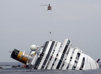 File photo: An Italian firefighter is lowered onto the Costa Concordia on 31 January.