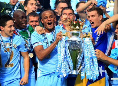 Vincent Kompany lifts the Premier League trophy.