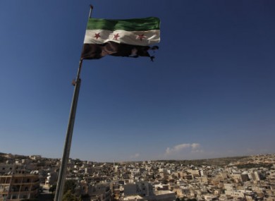 File photo of a Syrian revolutionary flag flying over Aleppo.