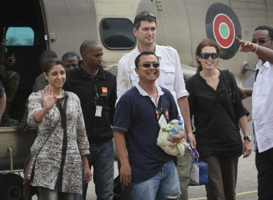 Released aid workers Horat Sadosay, Glenn Costes, centre, Steven Dennis, centre-back, and Astrid Sehl, center-right.