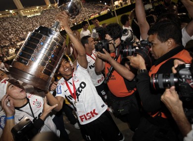 Corinthians' Romarinho, second from left, lifts the trophy at the end of the Copa Libertadores final.